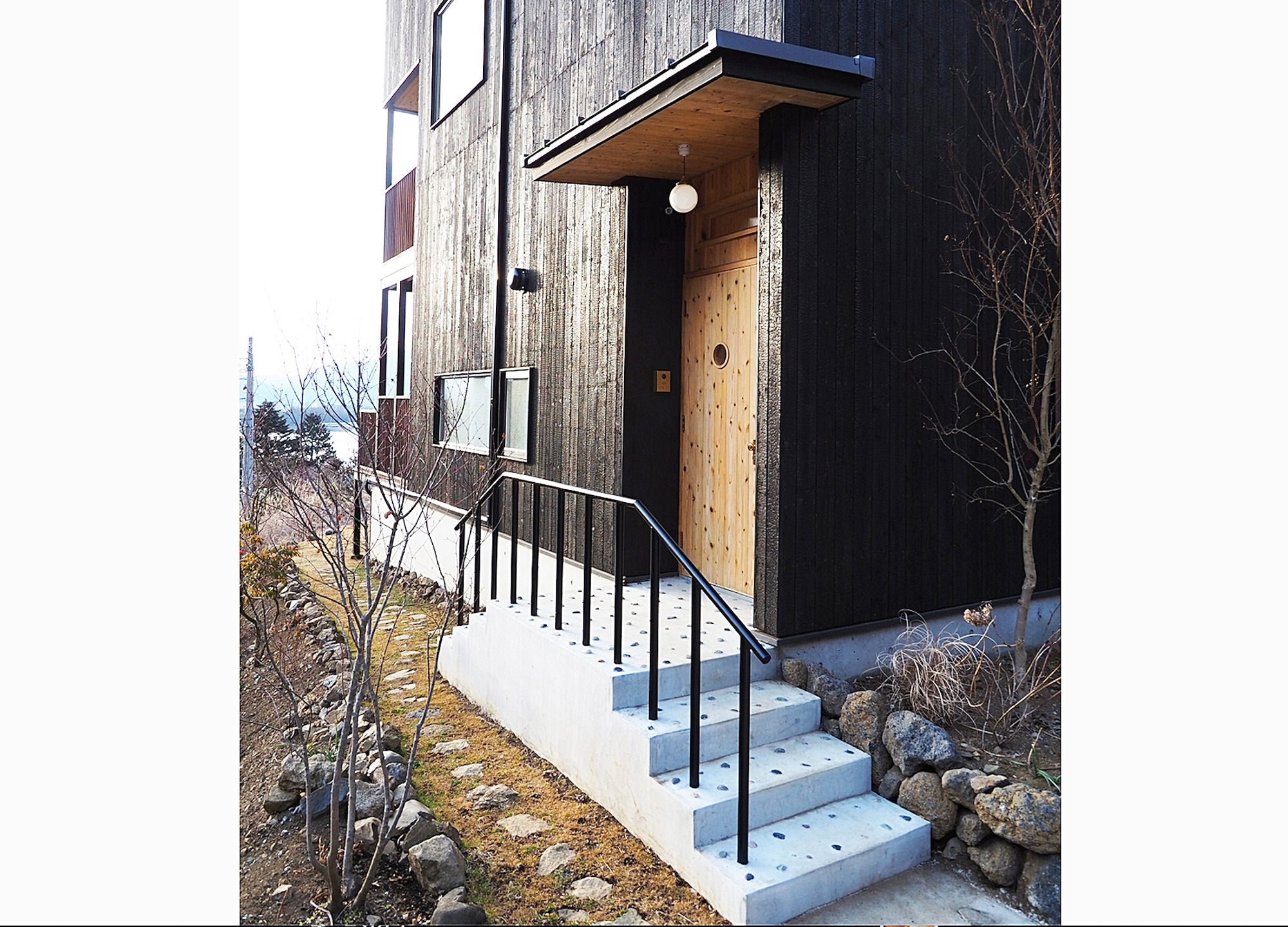 玄関周りです。外壁は焼杉、玄関周りと、軒天(軒の裏)だけ木の色をそのまま出しコントラストを付けました。